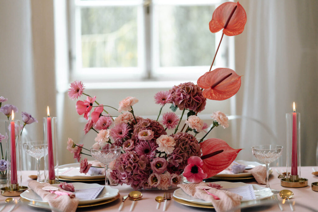 Blumengesteck steht auf Hochzeitstafel